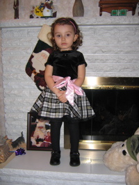 Last night she posed for pictures in her Christmas dress.