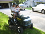Back at the homestead, she helped grandpa mow the lawn.