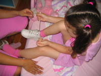 Learning to tie her shoes....