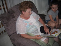 Grandma reading her a story.