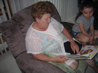 Grandma reading her a story.
