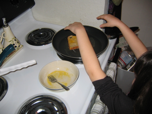 She liked throwing the frenchtoast on the pan.