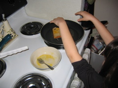 She liked throwing the frenchtoast on the pan.