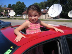 She likes riding the fast red car.