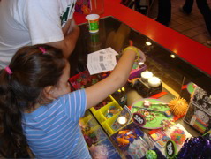 Novali spending her tickets from skeeball.