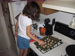 She careful laid oout the meatballs for the oven.