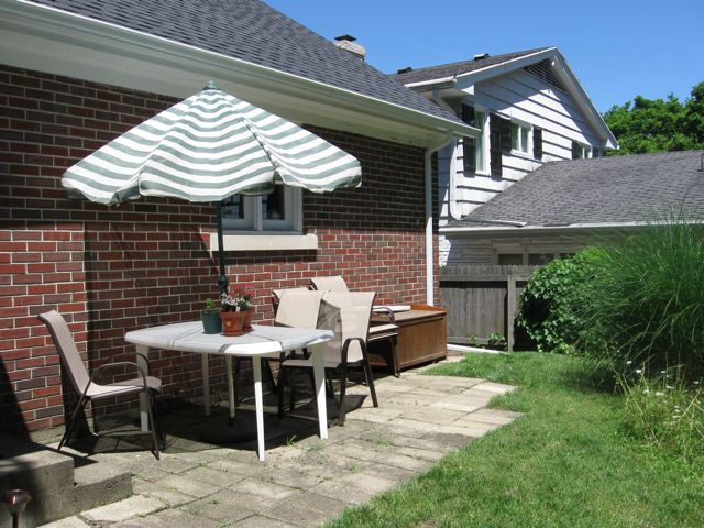 Repurposes tiles from old walking paths, added them to patio and cleared out unwanted plants. 